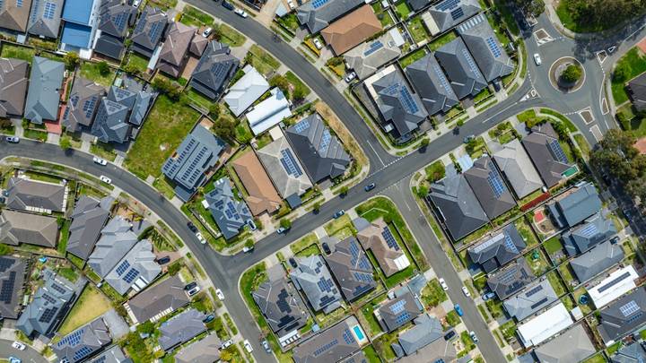 File image: Aerial view of suburban houses with solar panels and curved streets