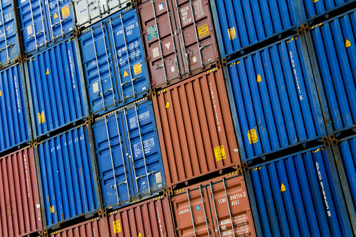 File image: Stacked blue and red shipping containers at a port