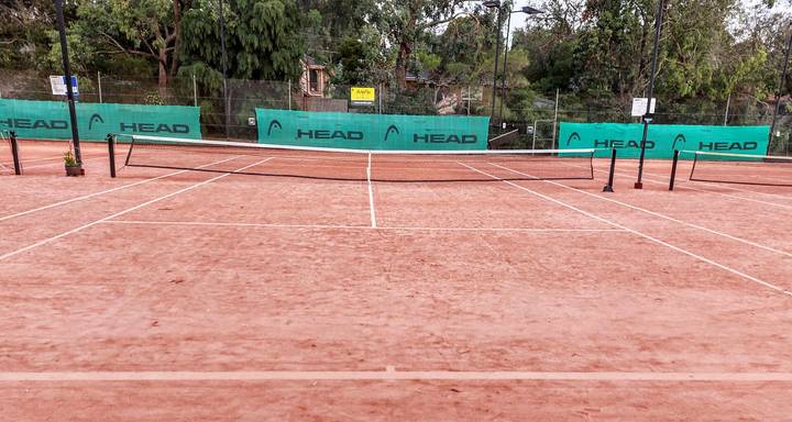 File image: Empty clay tennis court with HEAD sponsor boards