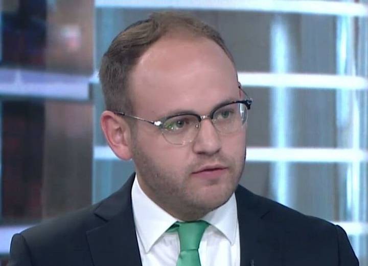 File image: Man in glasses and green tie presenting in broadcast studio setting