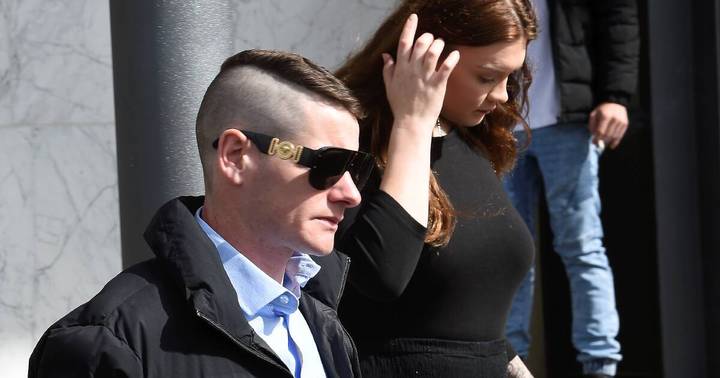 Bryce Dridan. Man in sunglasses and black jacket with woman at outdoor public event