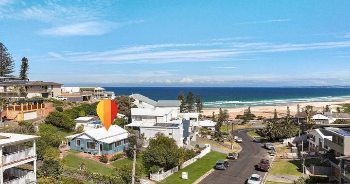 Aerial view of beachfront homes in Redhead with ocean and beach visible