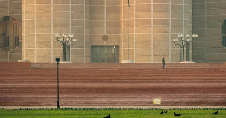 File image: Brick government or civic building with formal steps, minimal figures, clear sky.
