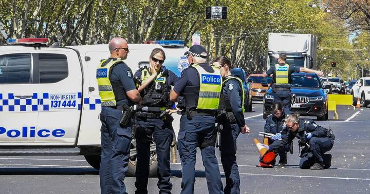 Australian police officers with marked van at public event