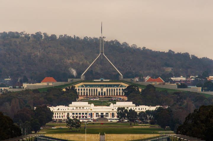 Parliament House in Canberra, viewed from elevated position showing distinctive pyramid roof and building.