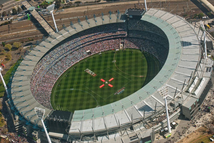 File image: Aerial view of packed oval sports stadium with green field