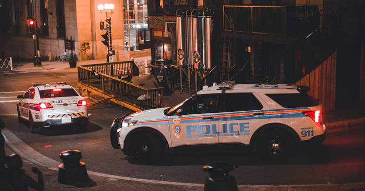File image: Police patrol vehicles parked on an urban street at night