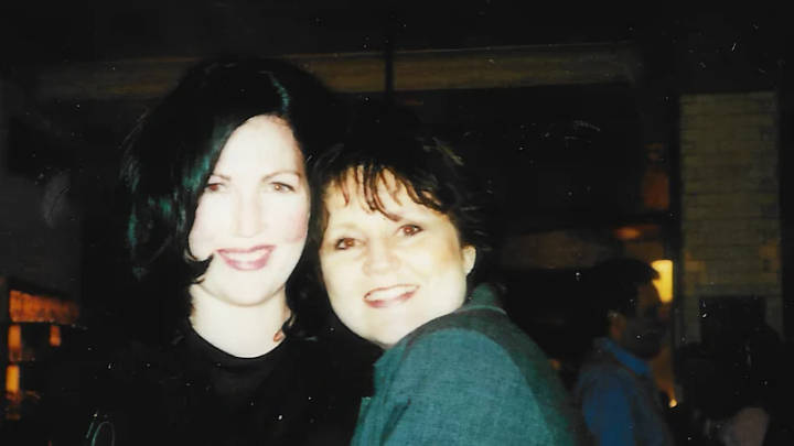 Two smiling women at indoor evening gathering, personal photograph