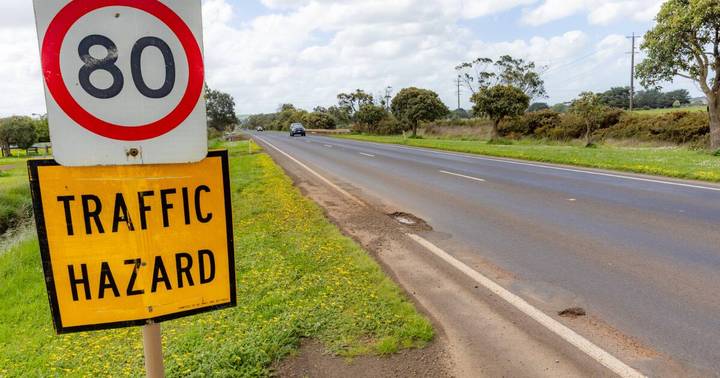 Speed limit 80 sign with Traffic Hazard warning on rural Australian highway