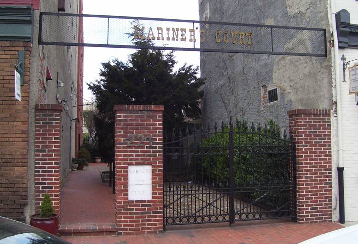 File image: Brick coroner's court entrance with iron gates and ivy-covered archway, neutral institutional setting.