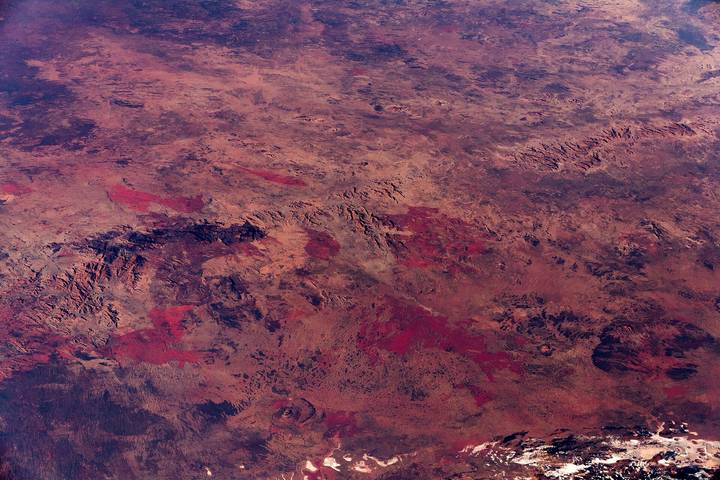 File image: High-altitude aerial view of red-brown arid outback terrain