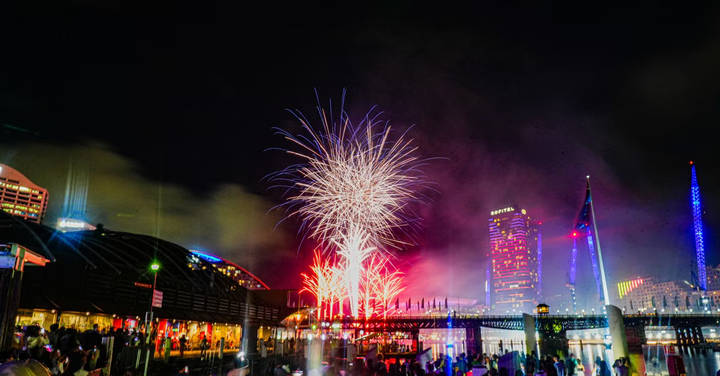 File image: Crowds gathered at riverside festival with fireworks bursting overhead at night