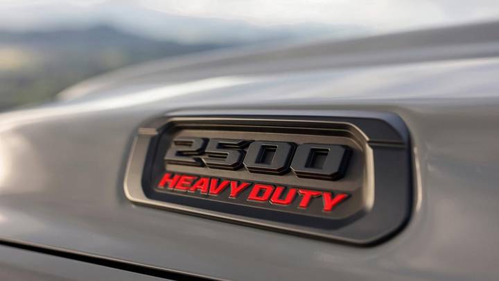 Close-up of Ram 2500 Heavy Duty truck badge with mountain landscape behind