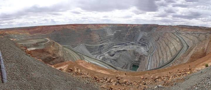 File image: Large-scale open-pit mining operation with terraced excavation levels and exposed geological strata