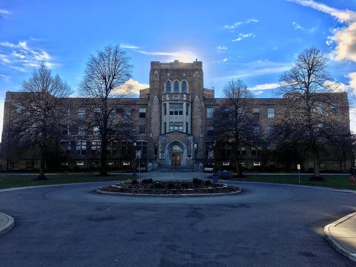 File image: Brick Gothic-style institutional building with central entrance and circular driveway.