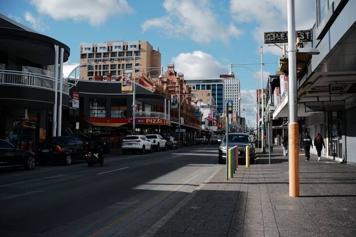 File image: Urban street scene with vehicles, storefronts and traffic infrastructure