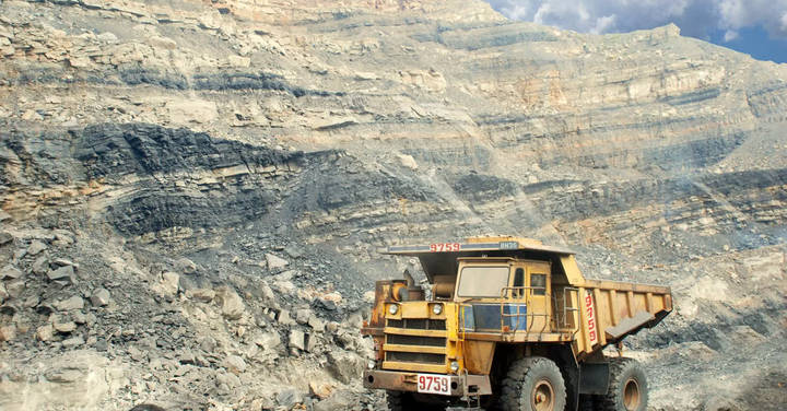 File image: Open-cut mine excavation with yellow ore truck operating