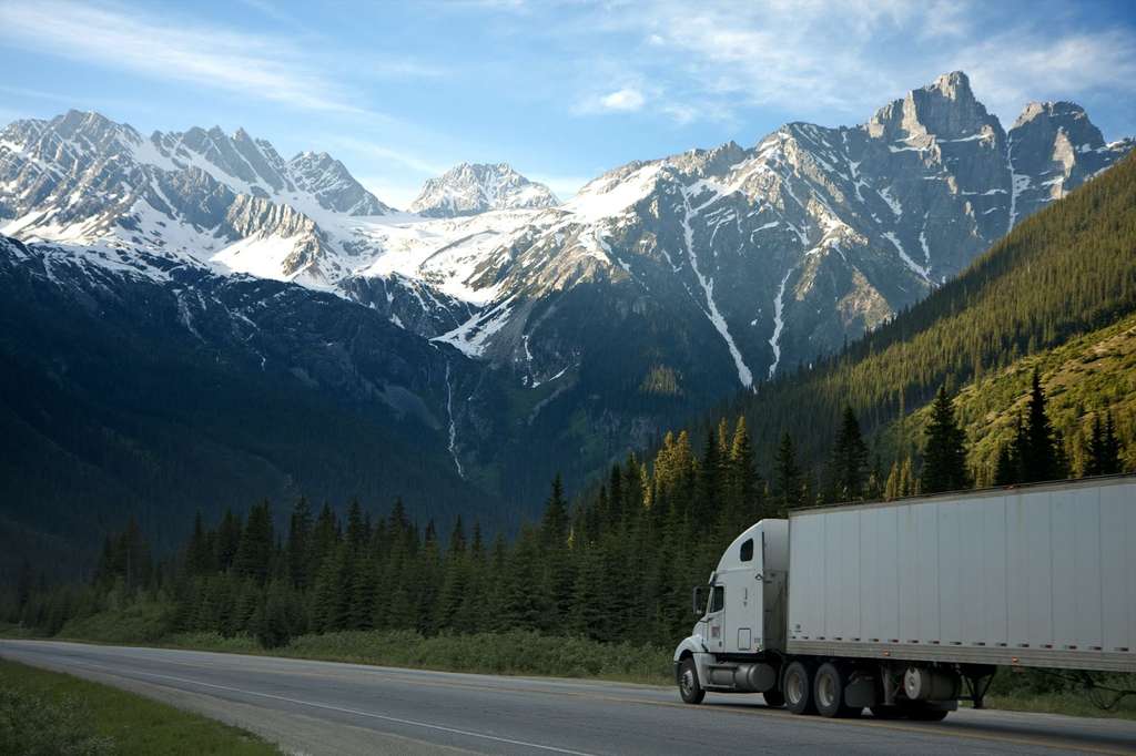 A truck is driving on a country road