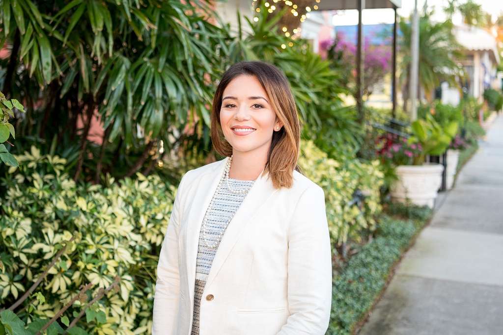 Real estate agent in suit with garden in the background