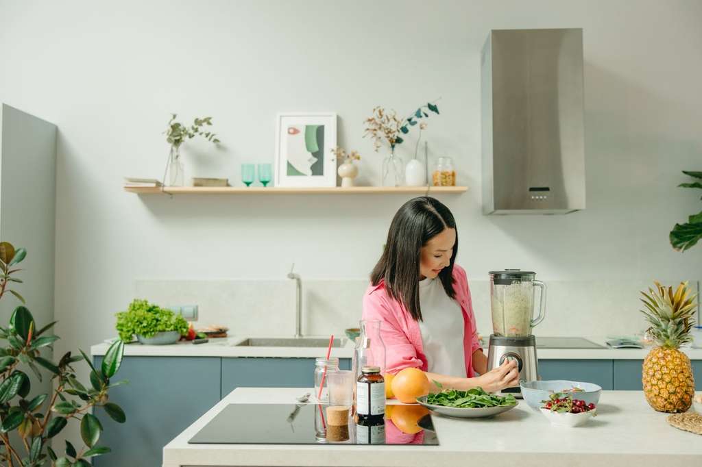 Nutritionist preparing a healthy meal in the kitchen.