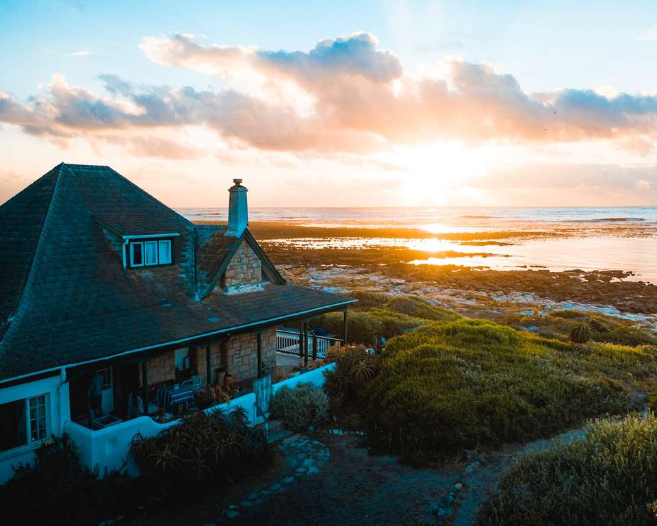 A vacation rental on the beach at sunset, with insurance coverage.