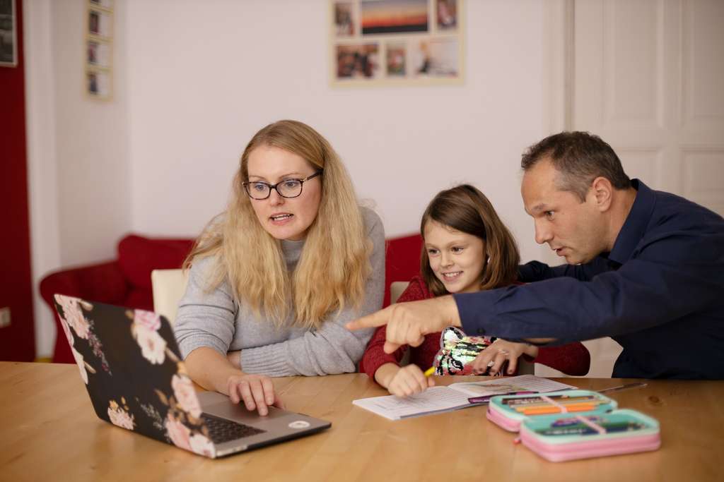 A family using a laptop at home.