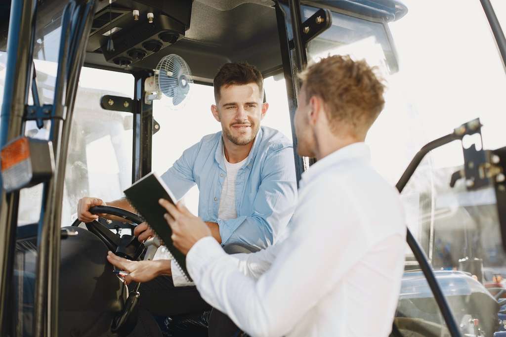 Show thumbnail preview	 Two men sitting in the driver's seat of a tractor, discussing telehandler insurance. Two men sitting in the driver's seat of a tractor, discussing telehandler insurance.