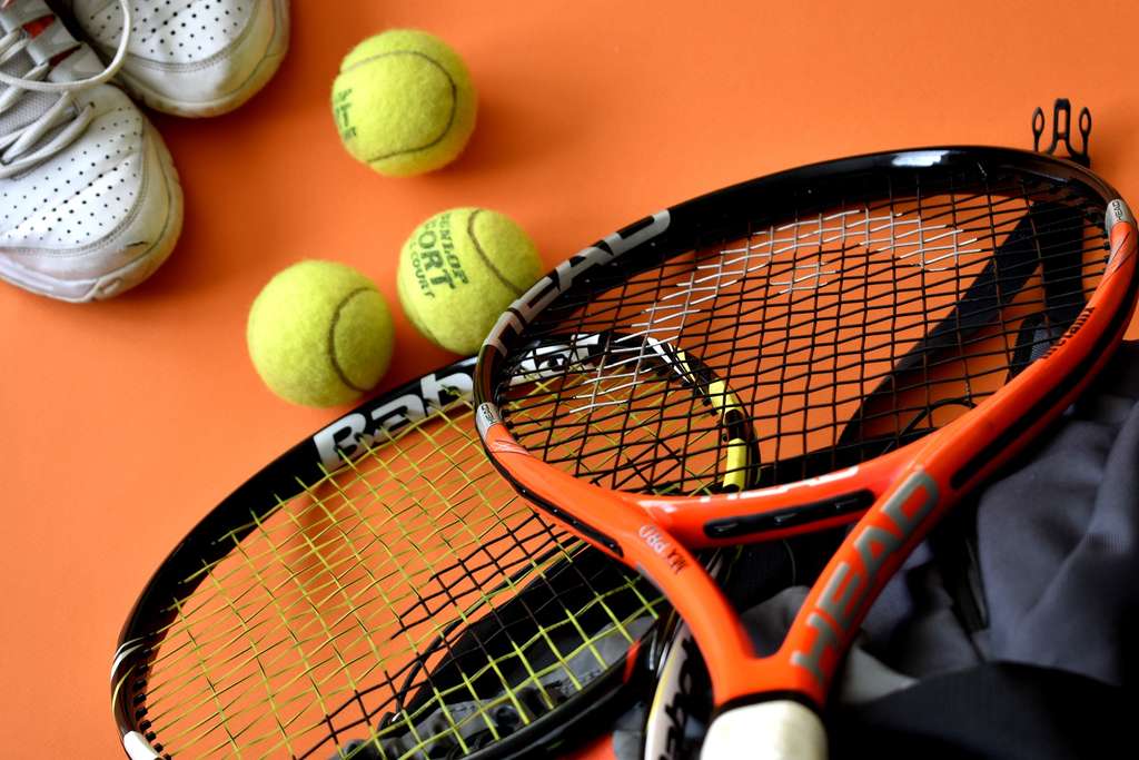 Show thumbnail preview	 Tennis rackets and balls on an orange background in a sporting goods store. Tennis rackets and balls on an orange background in a sporting goods store.