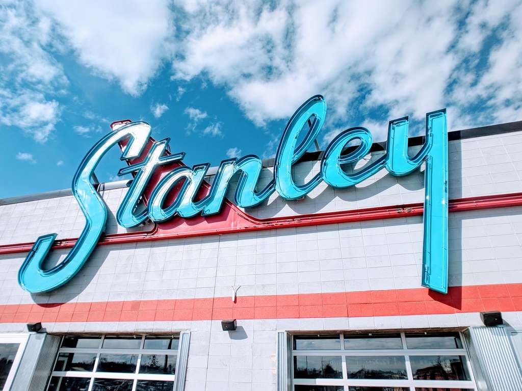 The signage installer mounted the Stanley sign on the side of a building.