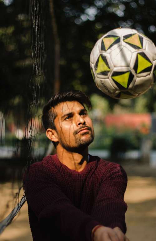 A man with a volleyball in his hand.