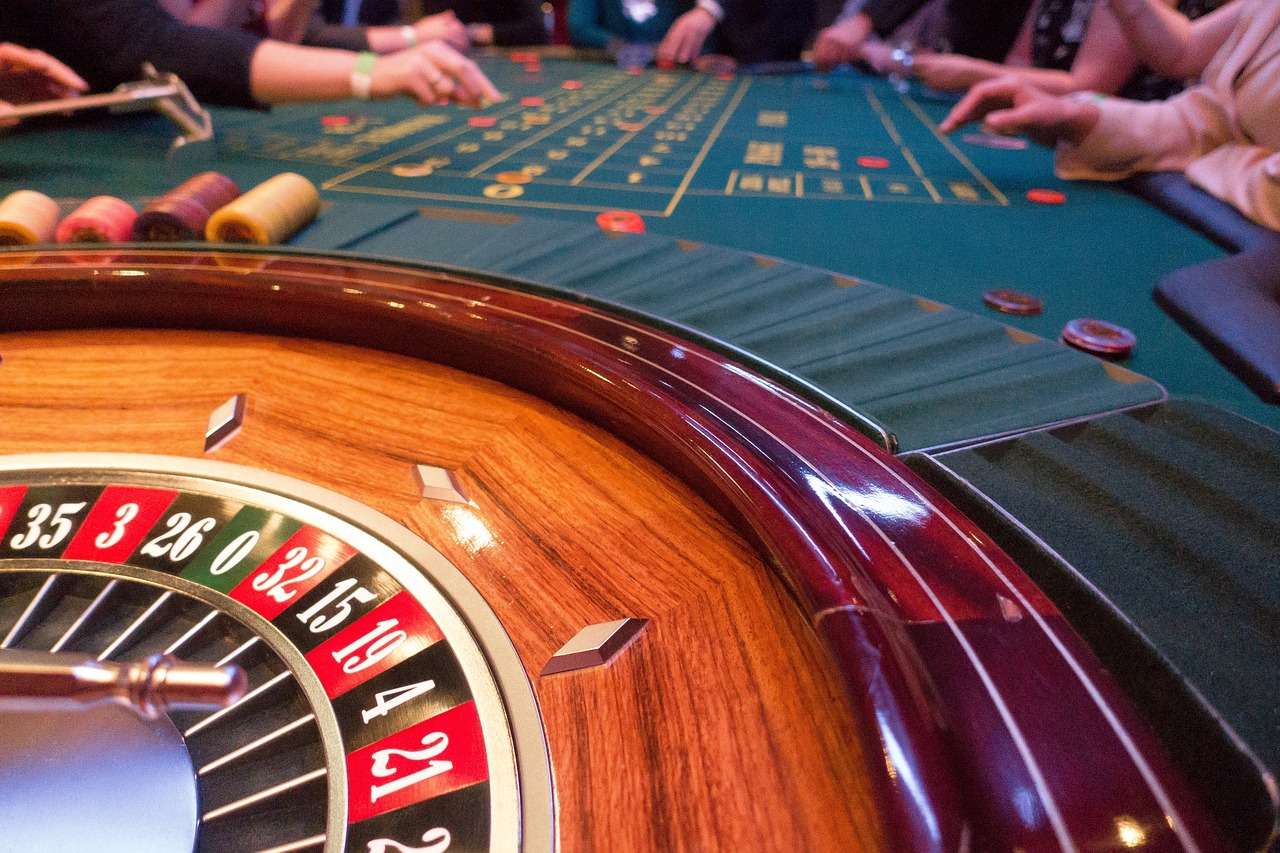 A casino table with a roulette wheel on it.