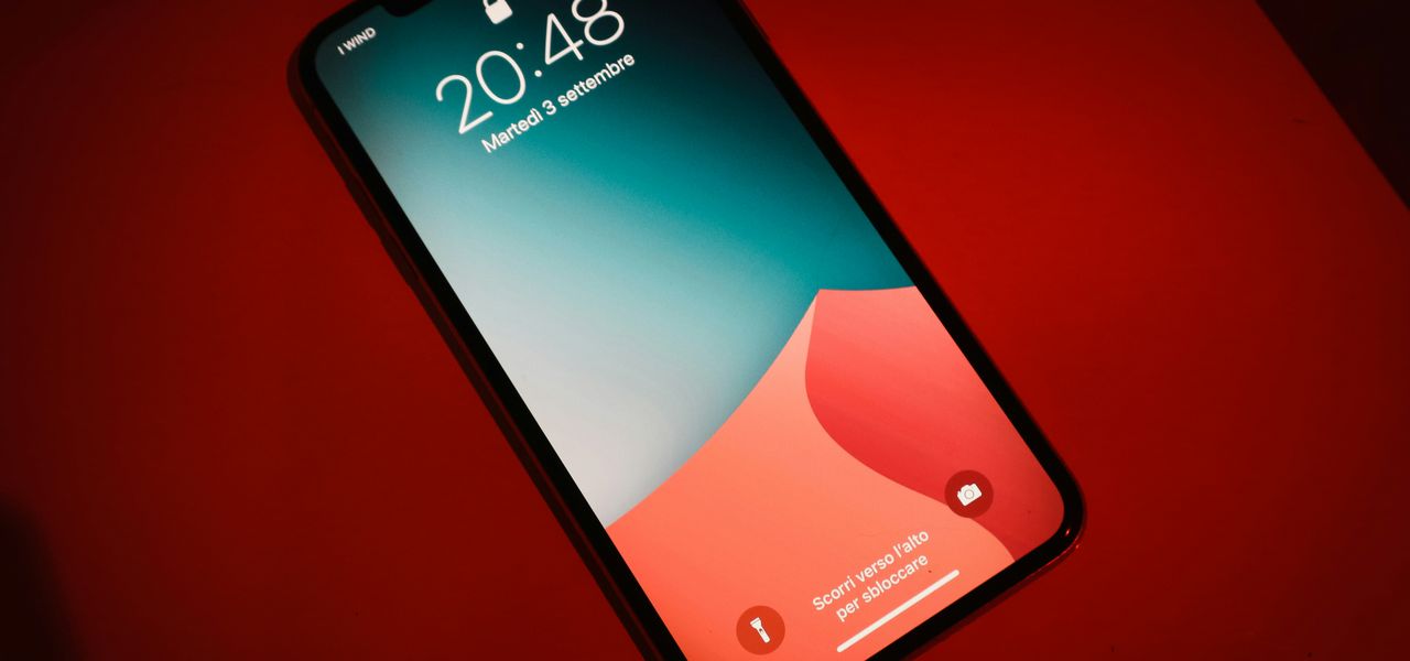 a close up of a cell phone on a red surface