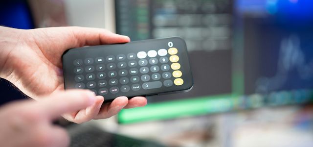 a person holding a remote control in their hand