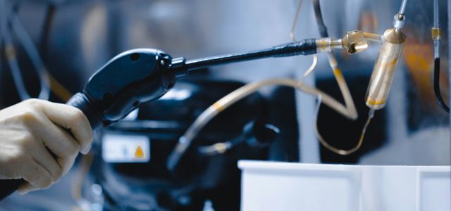 a person is working on a machine with a hose