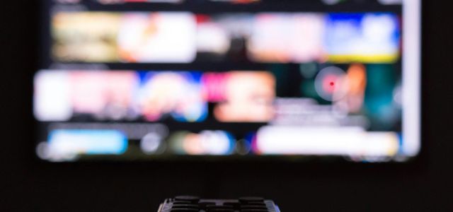 a remote control sitting in front of a television