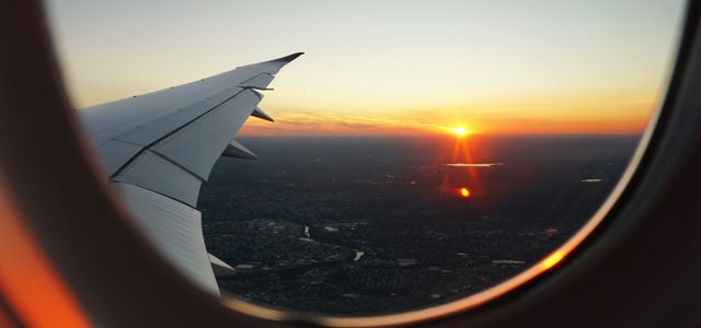 airplanes window view of sky during golden hour