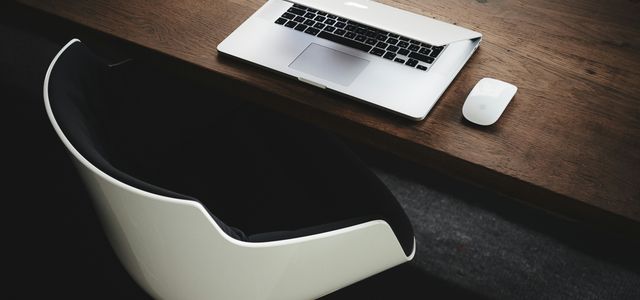 Apple MacBook beside computer mouse on table