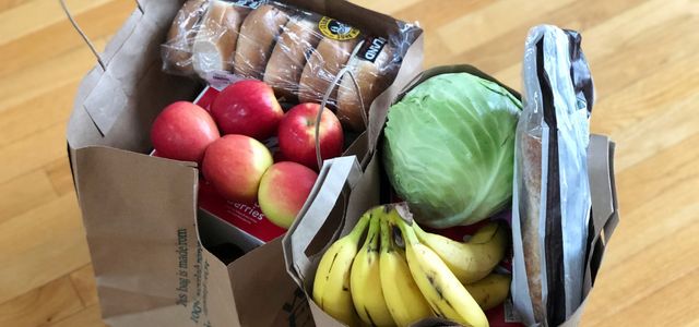 apples and bananas in brown cardboard box