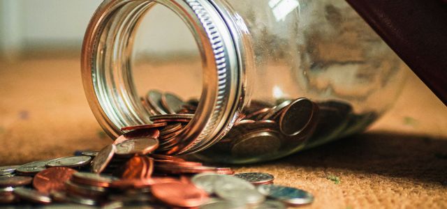 assorted coin lot in clear glass jar