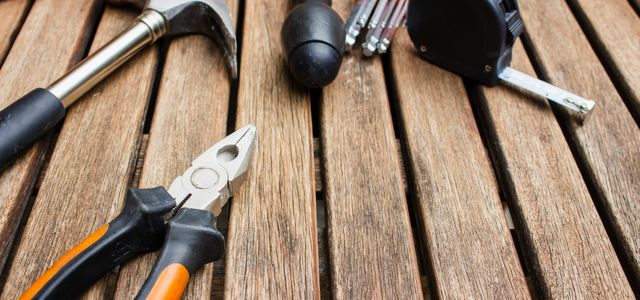 assorted-type carpentry tools on brown surface