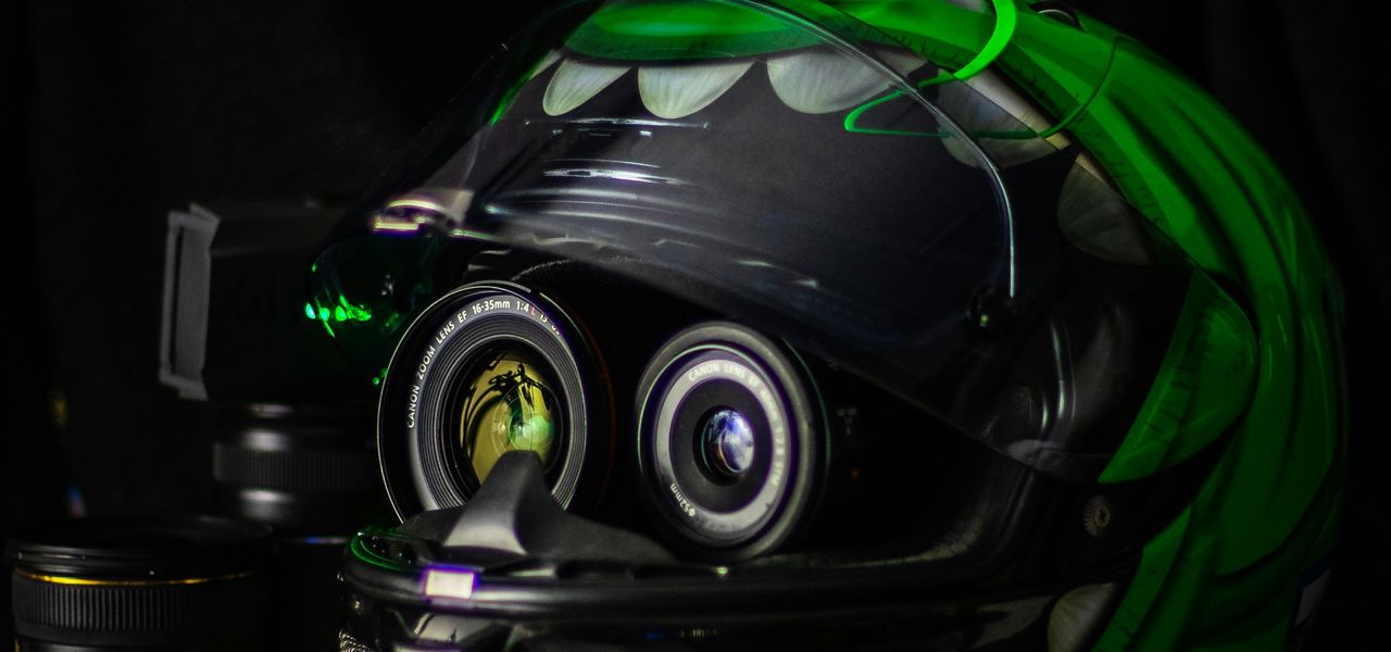 black and green full-face helmet on white wooden table
