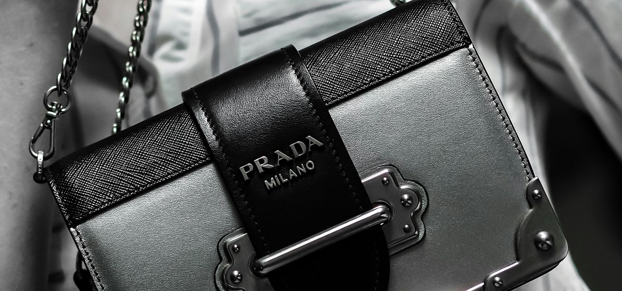 black leather handbag on white textile