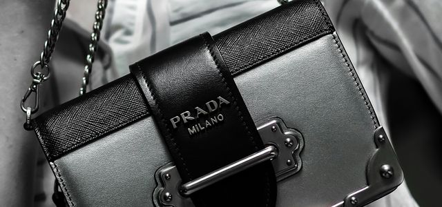 black leather handbag on white textile