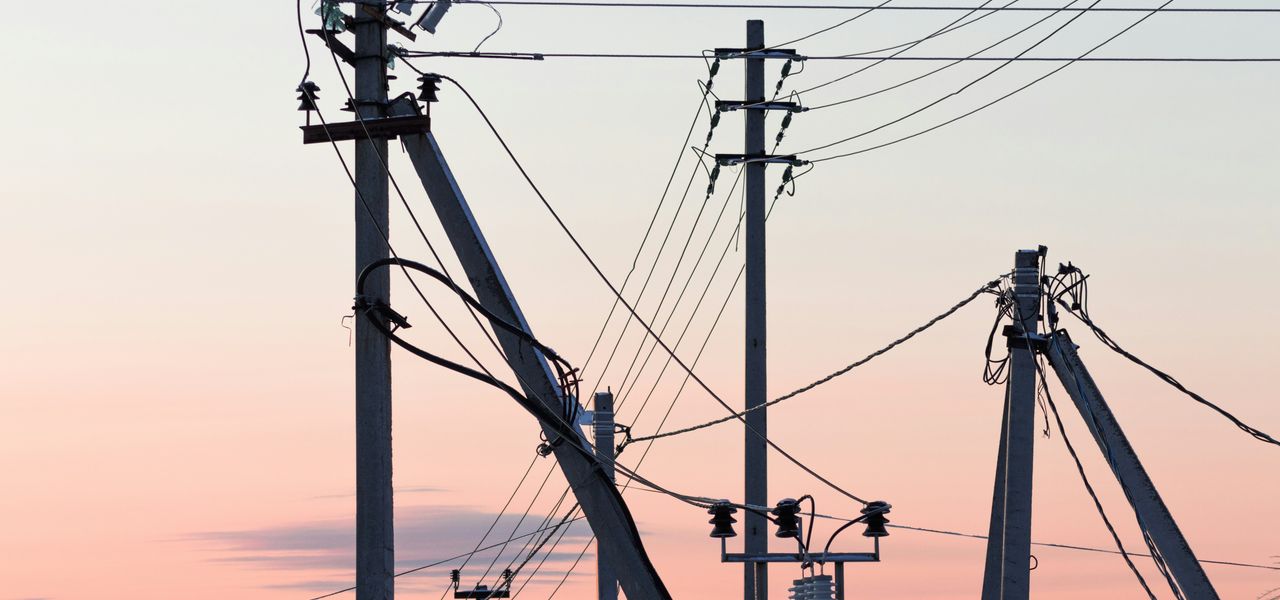 brown electric post under blue sky during daytime