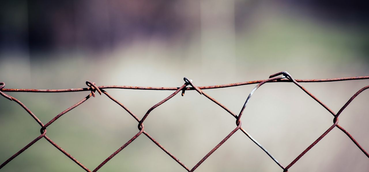 gray metal fence with barbwire