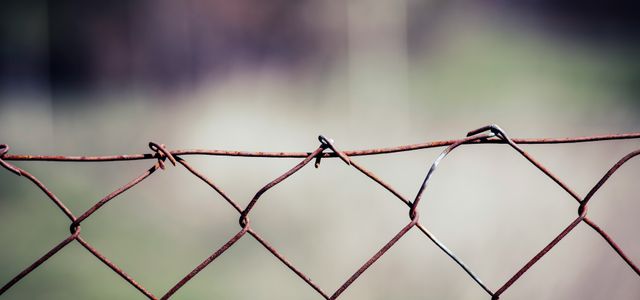 gray metal fence with barbwire