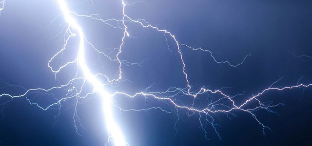 lightning strike during blue sky