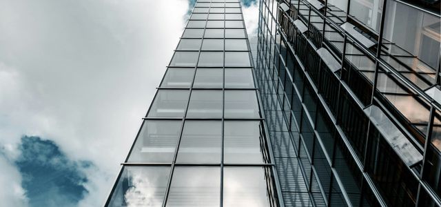 low angle photography of high rise building under cloudy sky