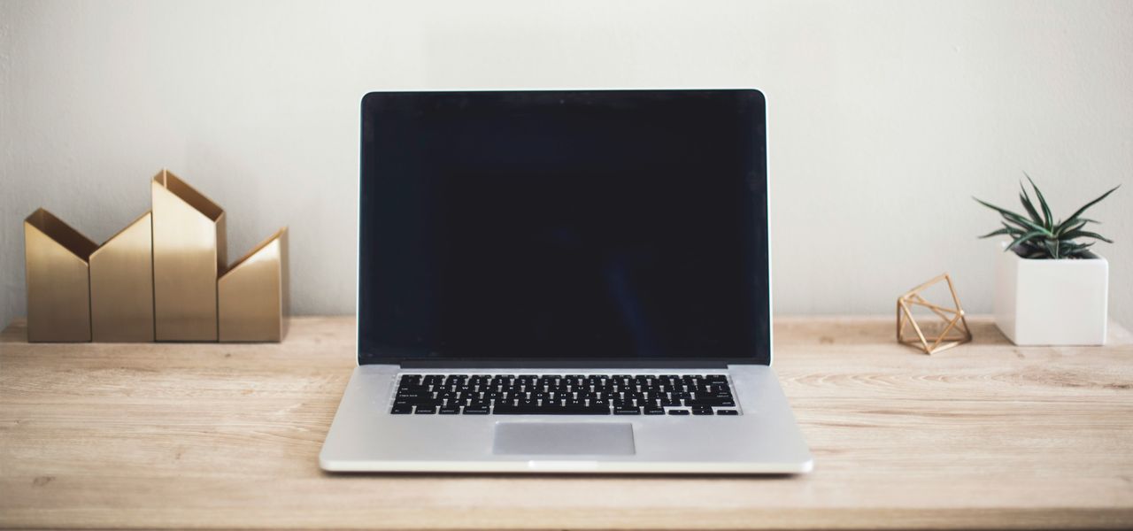 MacBook Pro on top of brown table