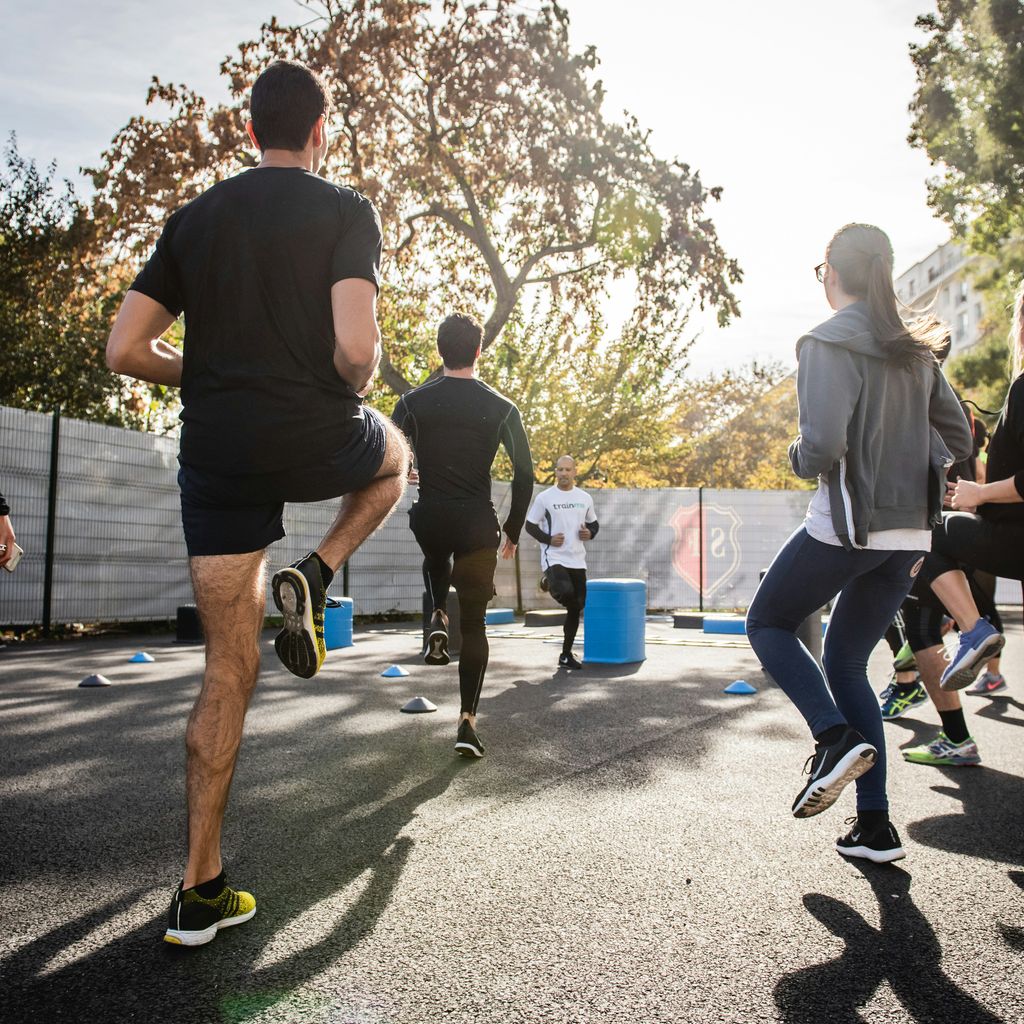 man in black t-shirt and black shorts running on road during daytime